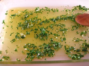 Oil, herbs, and seasonings in baking dish