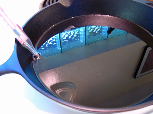 peanut oil in cast iron skillet and thermometer