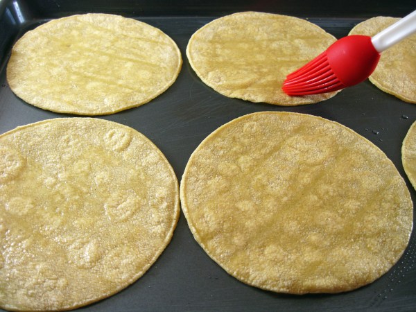 Brushing tortillas with oil