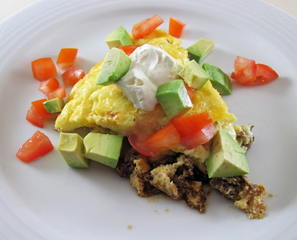 Easy Taco Pie with Sour Cream, tomato, and avocado